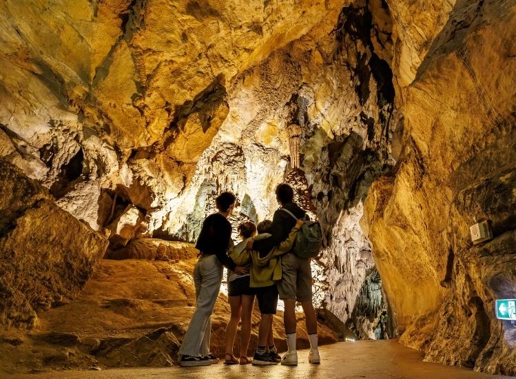 A family independently visiting the Grottes du Cerdon