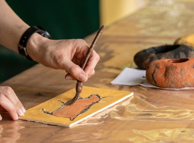 child's hand, paintbrush, prehistoric painting workshop, grottes du cerdon leisure park