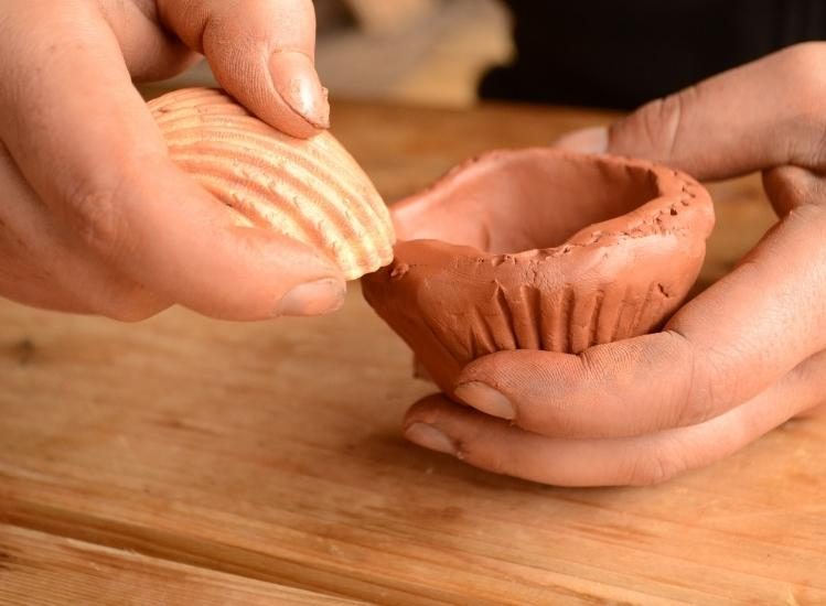 Child making Neolithic pottery in Grottes du Cerdon
