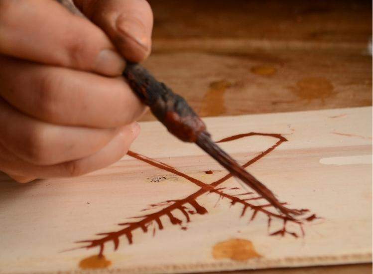 child's hand, paintbrush, prehistoric painting workshop, grottes du cerdon leisure park